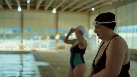 women preparing to swim at an indoor pool