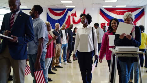 people waiting in line at a polling place to cast their votes