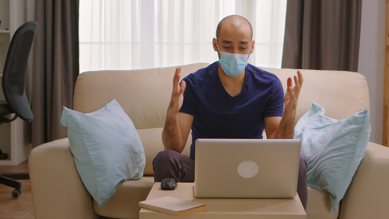 Man with protection mask on a business video call