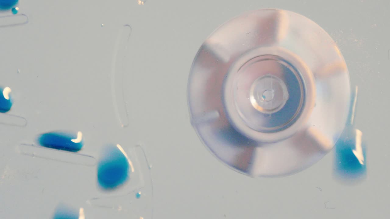 Spinning Cog and Blue Chemical Drops Scientific Experiment