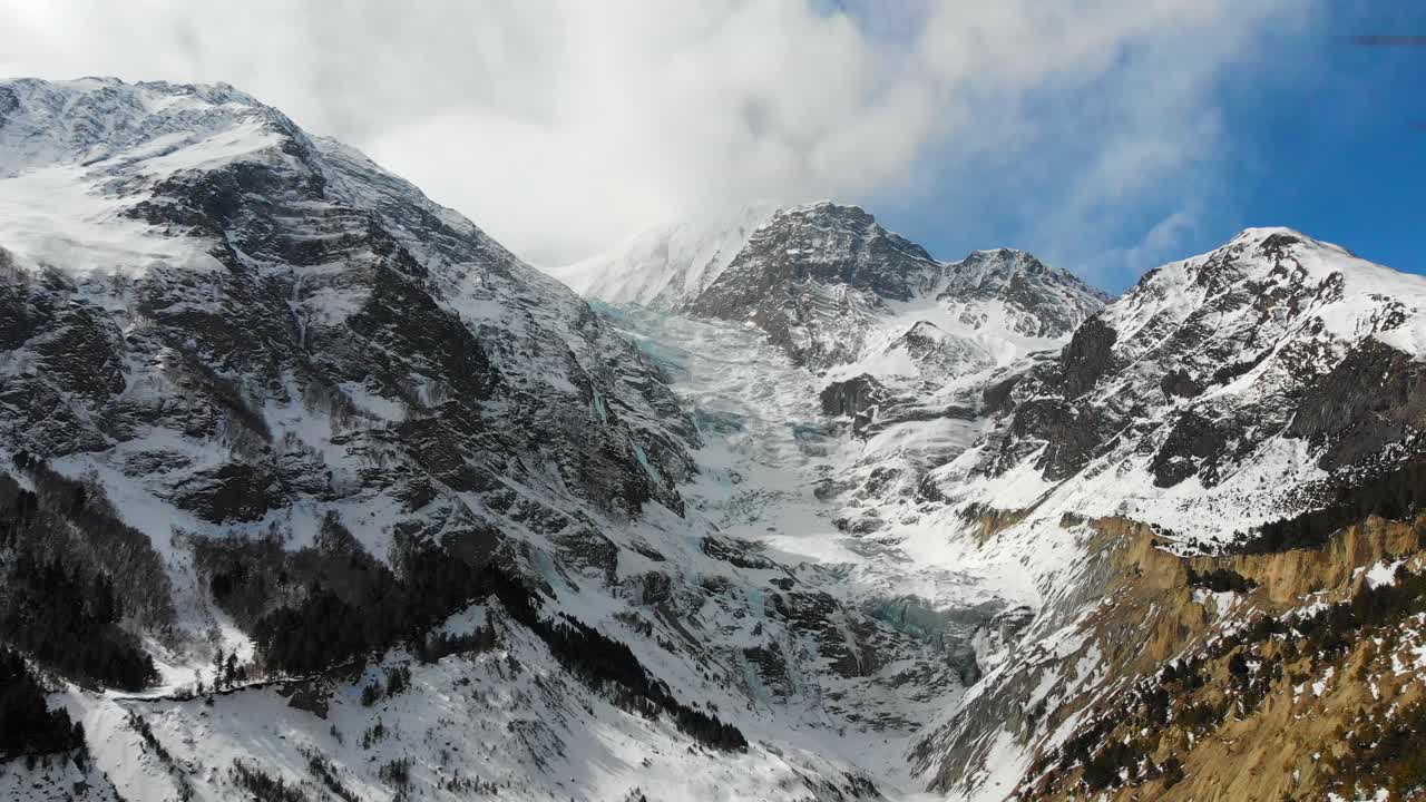 Aerial panning down shot of the huge glacier between Annapurna three and Gangapurna Himalaya Mountains in the Manang Valley, Nepal.
