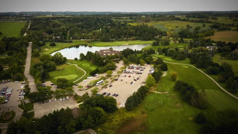 drone flying over a beautiful golf course surrounded by vast fields