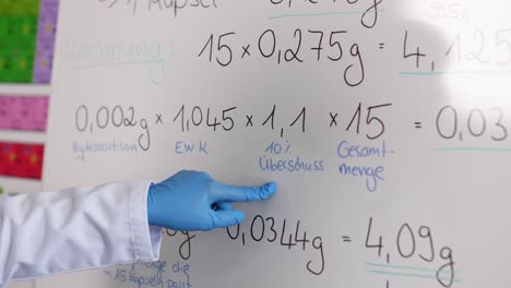 a calculation is shown on a blackboard - medical laboratory