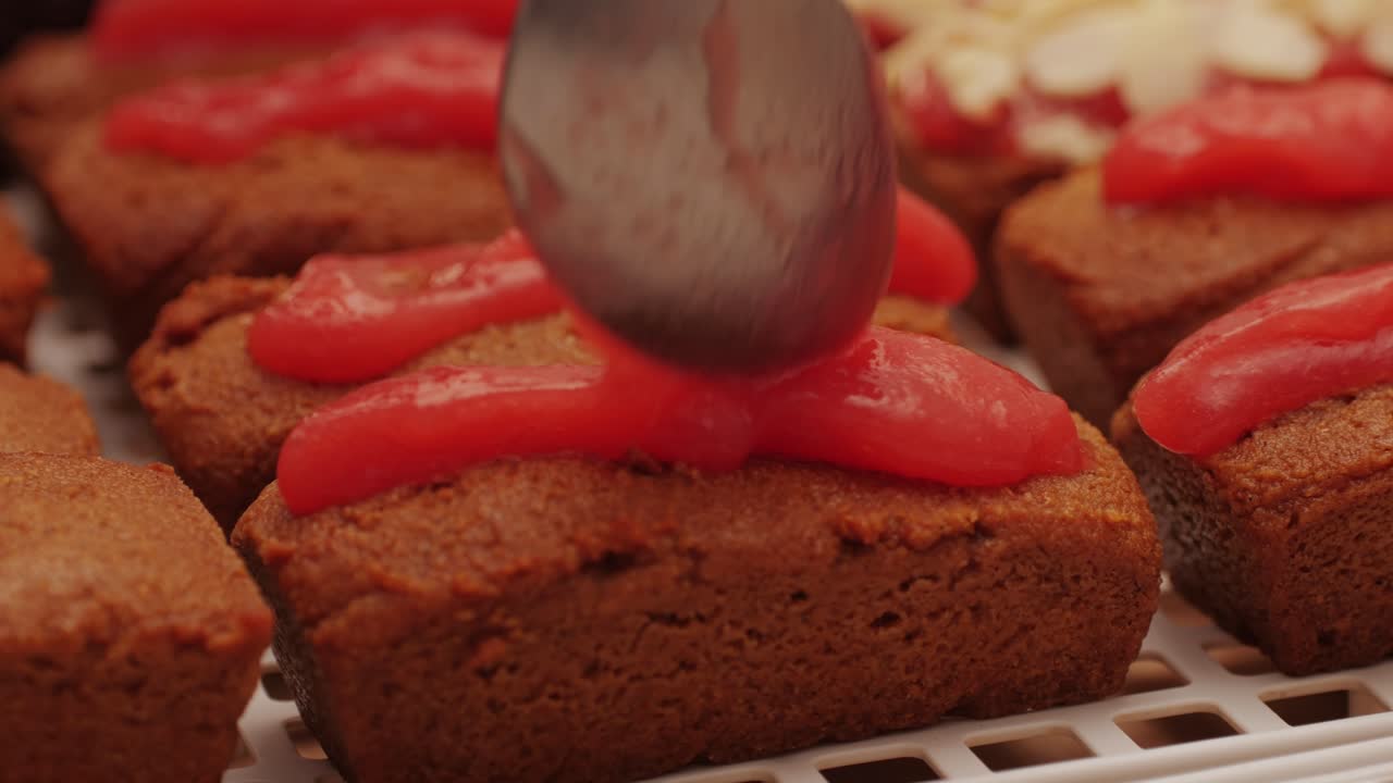 Artezan bread with red strawberry jam on top, fresh bake double chocolate banana artesian bread in bakery shop close-up. Artisan bread is making by skill bakers using natural and high-quality ingredients. Food with health and flavour benefits. Sweet breads for dessert and breakfast