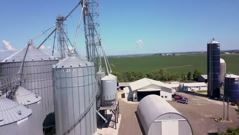 low flight over corn field to reveal grain bins on farm