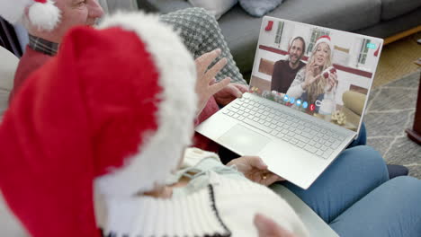 Two-happy-caucasian-couples-having-christmas-laptop-video-call,-slow-motion