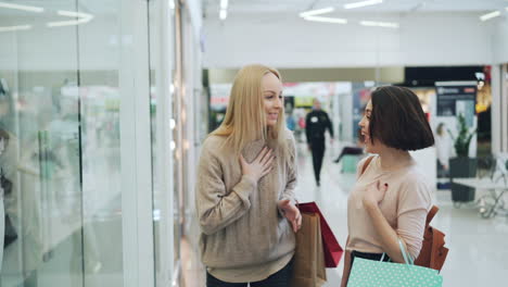 two women shopping in a mall
