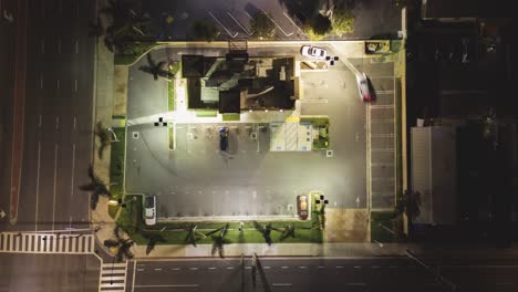 top-down-aerial-time-lapse-of-a-fast-food-restaurant-serving-customers-at-drive-thru-at-night