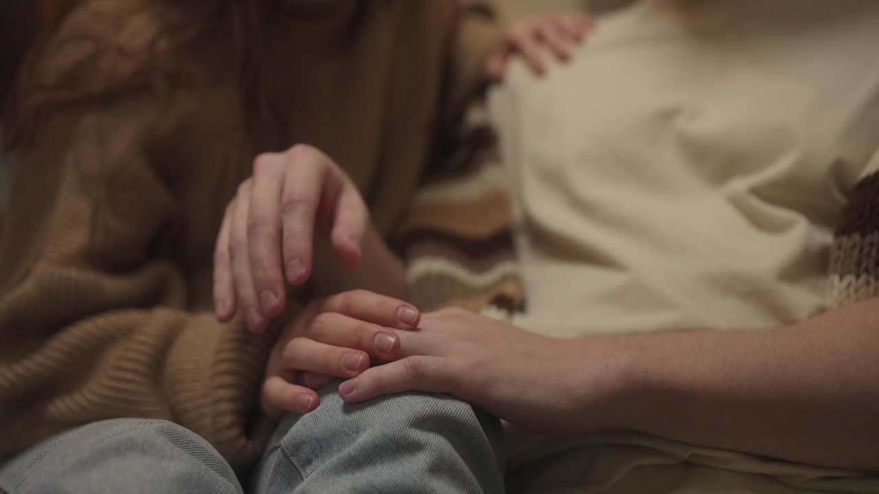 Couple Holding Hands for Comfort and Support