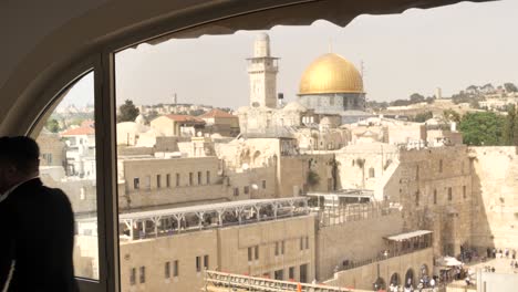 Unique-window-view-on-Temple-Mount,-Jerusalem-and-Jewish-man-going-for-prayer