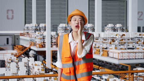 woman factory worker shouting in a warehouse