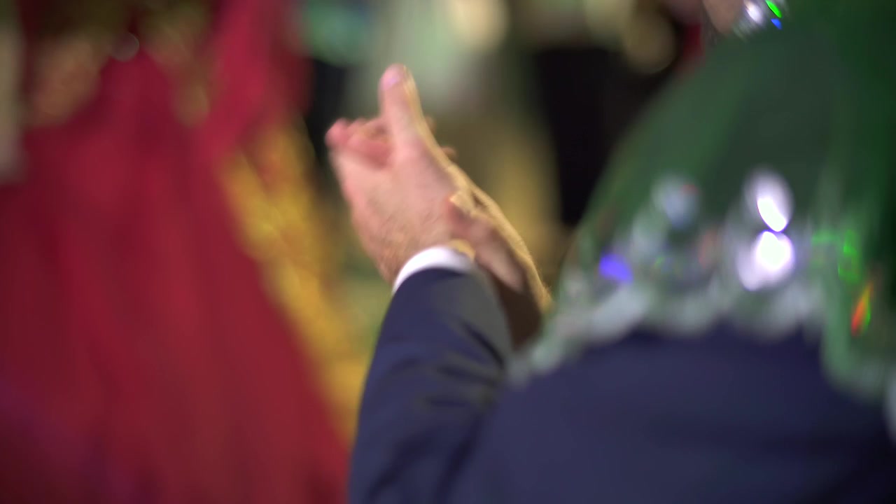 Man Clapping Hands at a Festive Celebration