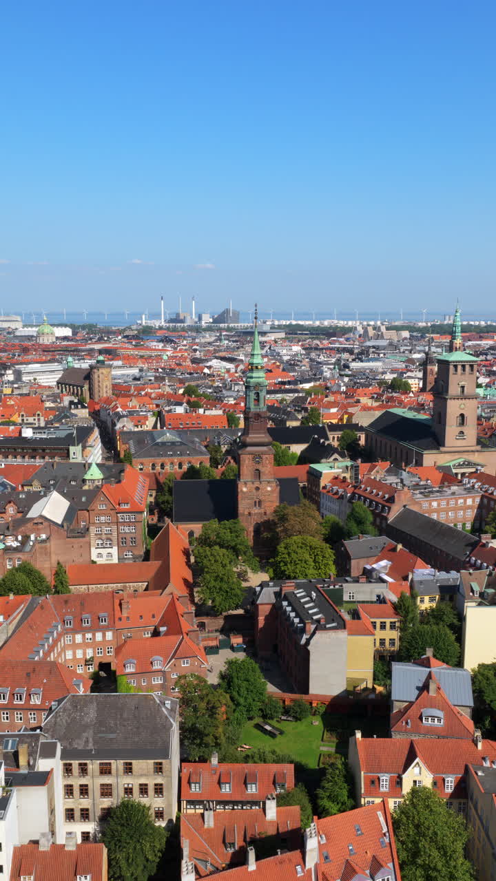 Aerial drone view of St. Peter's Church and Copenhagen skyline at sunrise, Denmark. Vertical