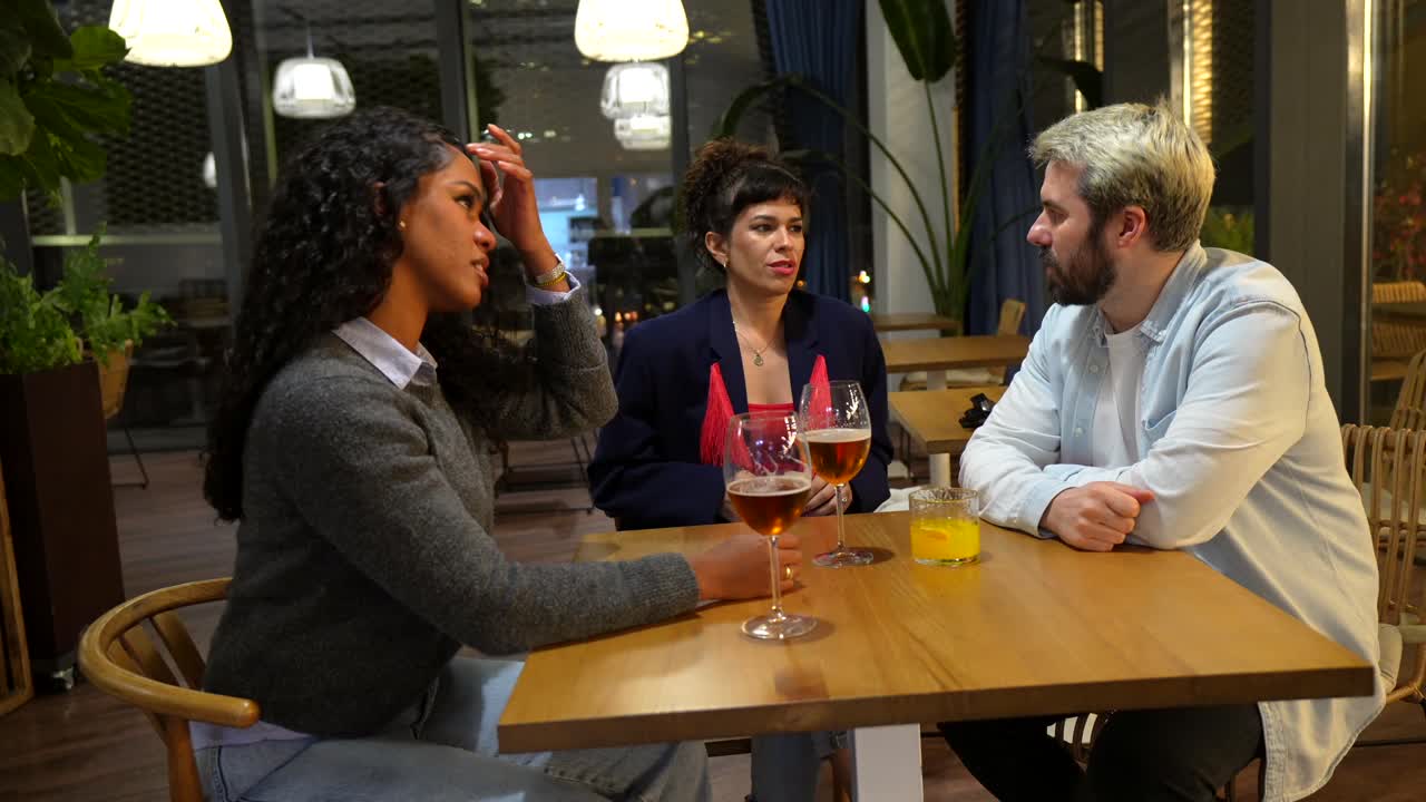 People having a conversation at a restaurant table