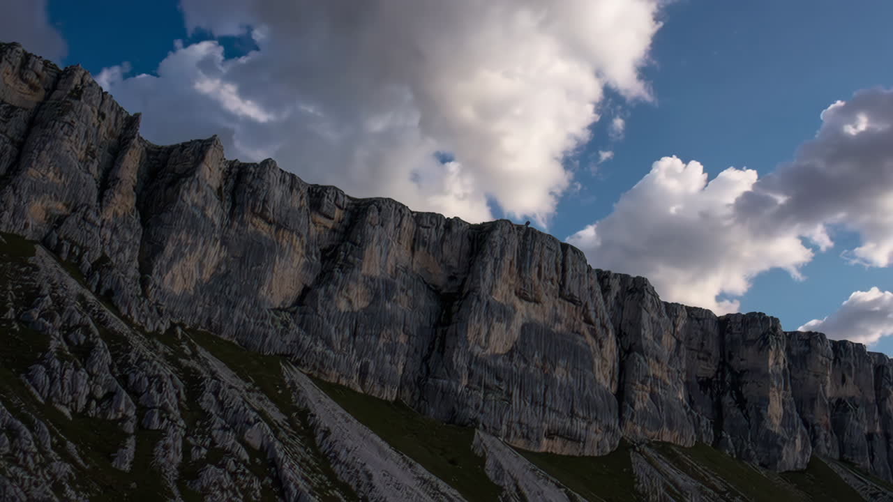 Mountain Cliff Face Under Dramatic Sky