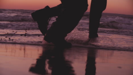 male dancer swipes up water at magic hour, 240 fps closeup