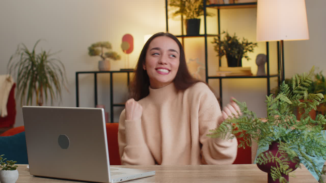 Happy caucasian woman having fun dancing dabbing raising hands making dub dance gesture at home room