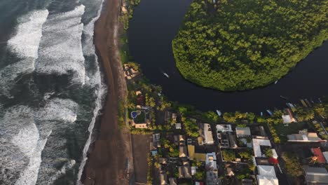 Top-down-view-of-El-paredon-black-sand-beach-during-sunrise,-aerial