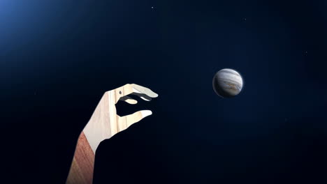 A stylized wooden hand reaching for Jupiter in space