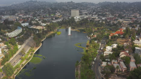 AERIAL:-Over-Echo-Park-in-Los-Angeles,-California-with-Palm-Trees,-Cloudy