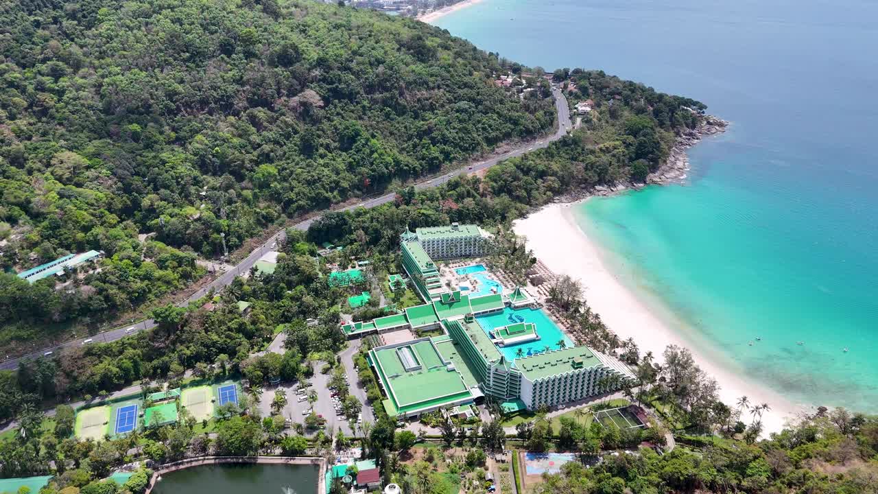 Drone footage captures a luxury resort in Phuket, Thailand, highlighting lush greenery, turquoise waters, and pristine beaches