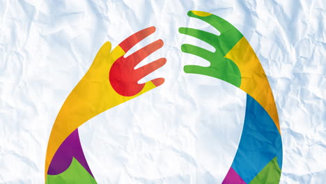 Animation of hands in autism awareness puzzles over crumpled paper