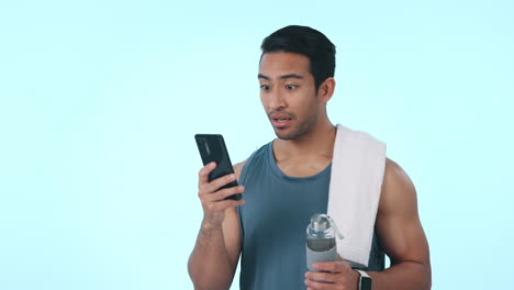 Happy-asian-man,-phone-and-celebration-in-fitness