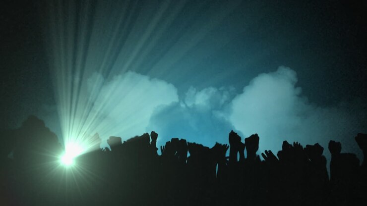 Animation of silhouettes of people dancing at concert spotlights moving