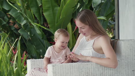 baby watching mother clapping hands