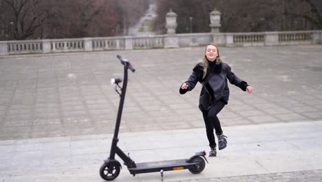 woman riding an electric scooter in a park