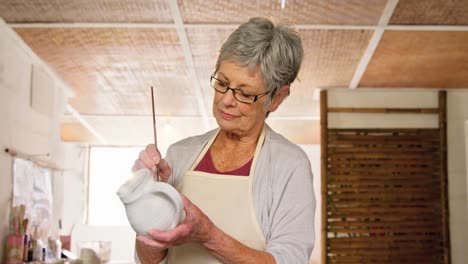 Female-potter-painting-a-jug