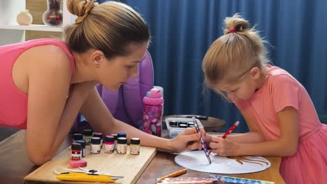 mother and daughter painting together