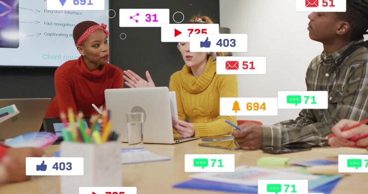 Team at laptop, woman speaking, initiating swelling and thinning social counters showing metrics
