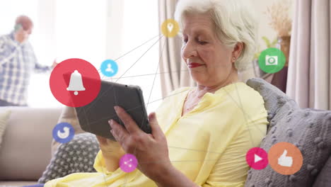 animation of social media icons and data over smiling senior caucasian woman with smartphone