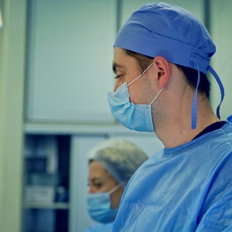 professional doctors and a nurse in the intensive care unit. surgeons in medical uniform and masks performing an operation in the hospital.