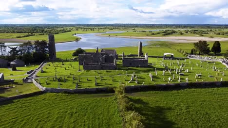 a pull back drone shot of the river shannon backdrop to the ancient clonmacnoise monastery in county offaly ireland