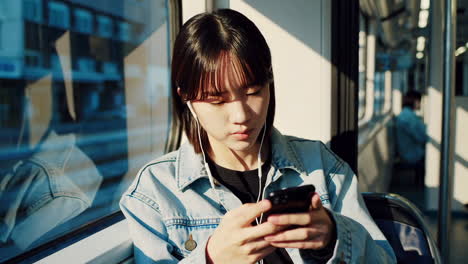young woman using smartphone on a train