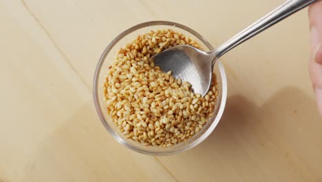 korean sesame seed  scooping from bowl