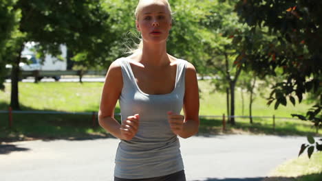 A-woman-jogs-while-looking-around-