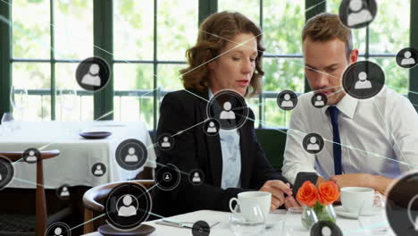 network of connections animation over business people discussing in restaurant