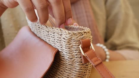 woman's hands close up with straw bag