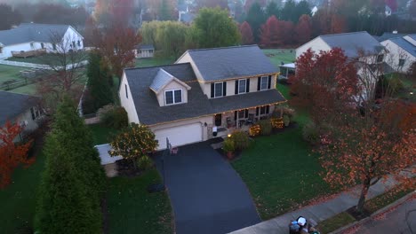 Two-story-traditional-American-home-decorated-with-Christmas-lights-at-holidays