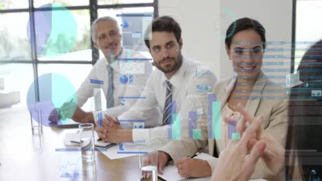 Animation-of-data-processing-over-rear-view-of-businesswoman-talking-to-diverse-colleagues-at-office