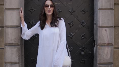 Young-fashionable-happy-and-smiling-woman-posing-in-city-street