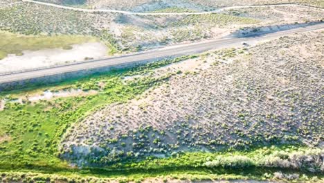 desert highway at sunset and dusk with a snake river and plateaus from a drone in 1080p summer of 2018