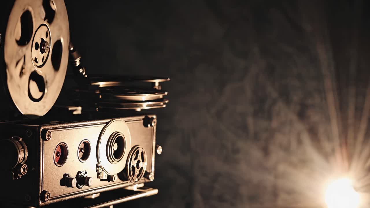 Vintage film projector casting light, captured from a side angle