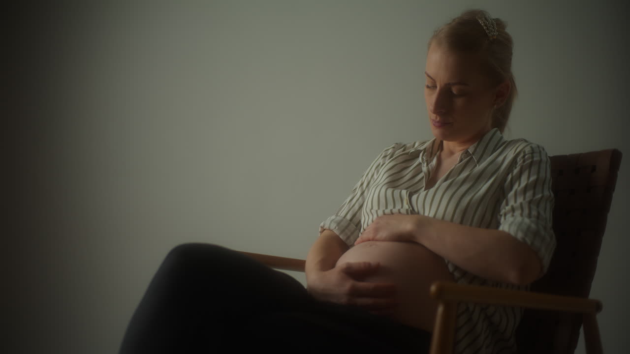 Close Up Of Pregnant Woman Massaging Belly