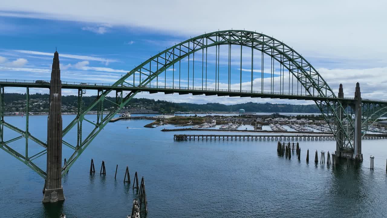 Aerial view flying under the Yaquina Bay Bridge, toward the marina in Newport, USA