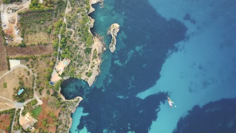 breathtaking top down shot in 4k of es pontas in mallorca - majorca spain with sailing boats in quiet mediterranean sea