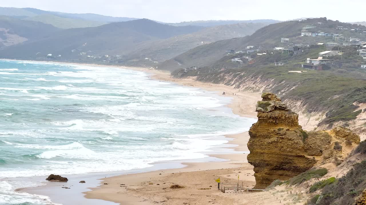 Sweeping views of rugged cliffs and ocean waves under soft daylight along Australia's Great Ocean Road